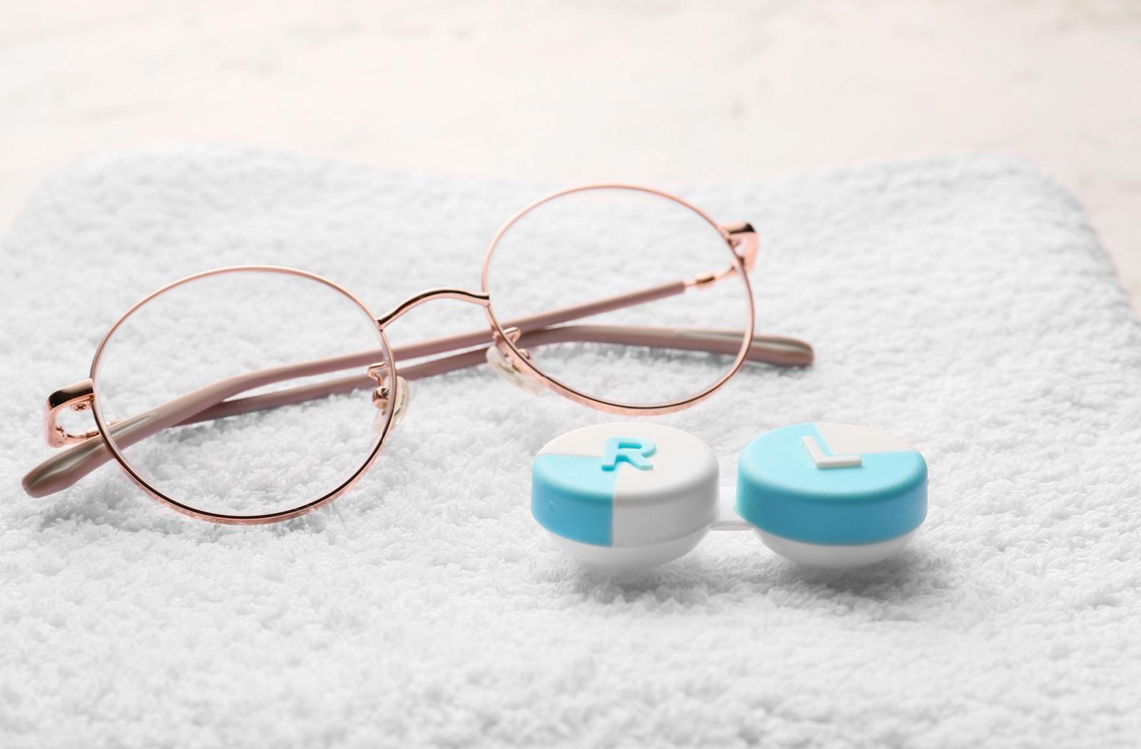 A pair of eye glasses and contact lens case.